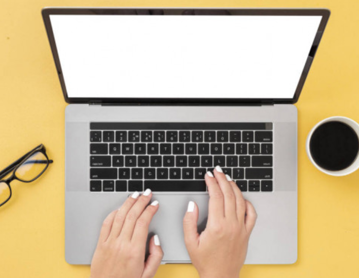 hands typing at computer