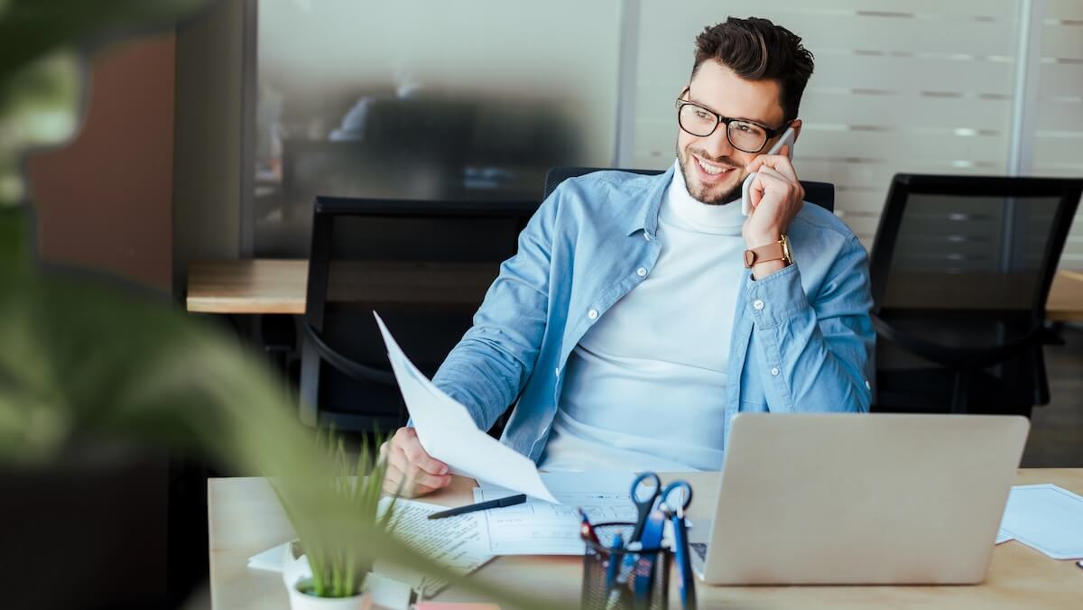 salesman on phone smiling