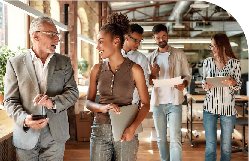 JourneyTeam homepage hero image showing a team of professionals collaborating in a modern office environment.