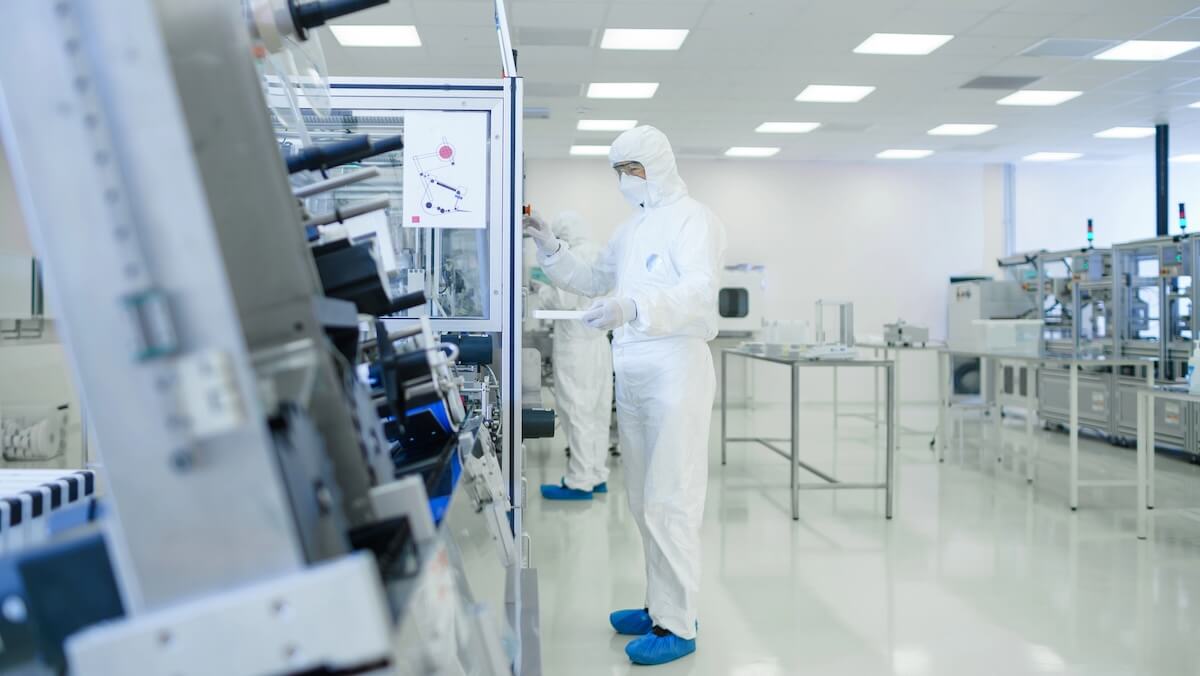 Modern regulated manufacturing facility with automated machinery and safety-compliant production lines.